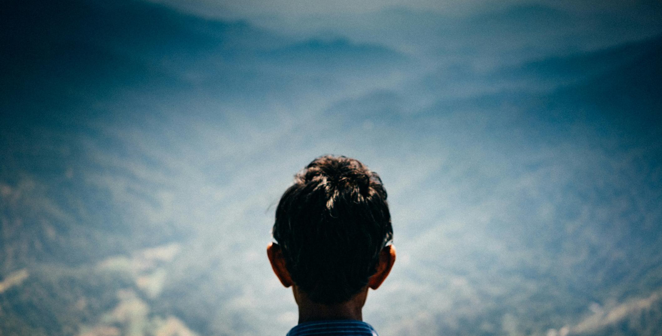 Back of man's head in found of mountain landscape