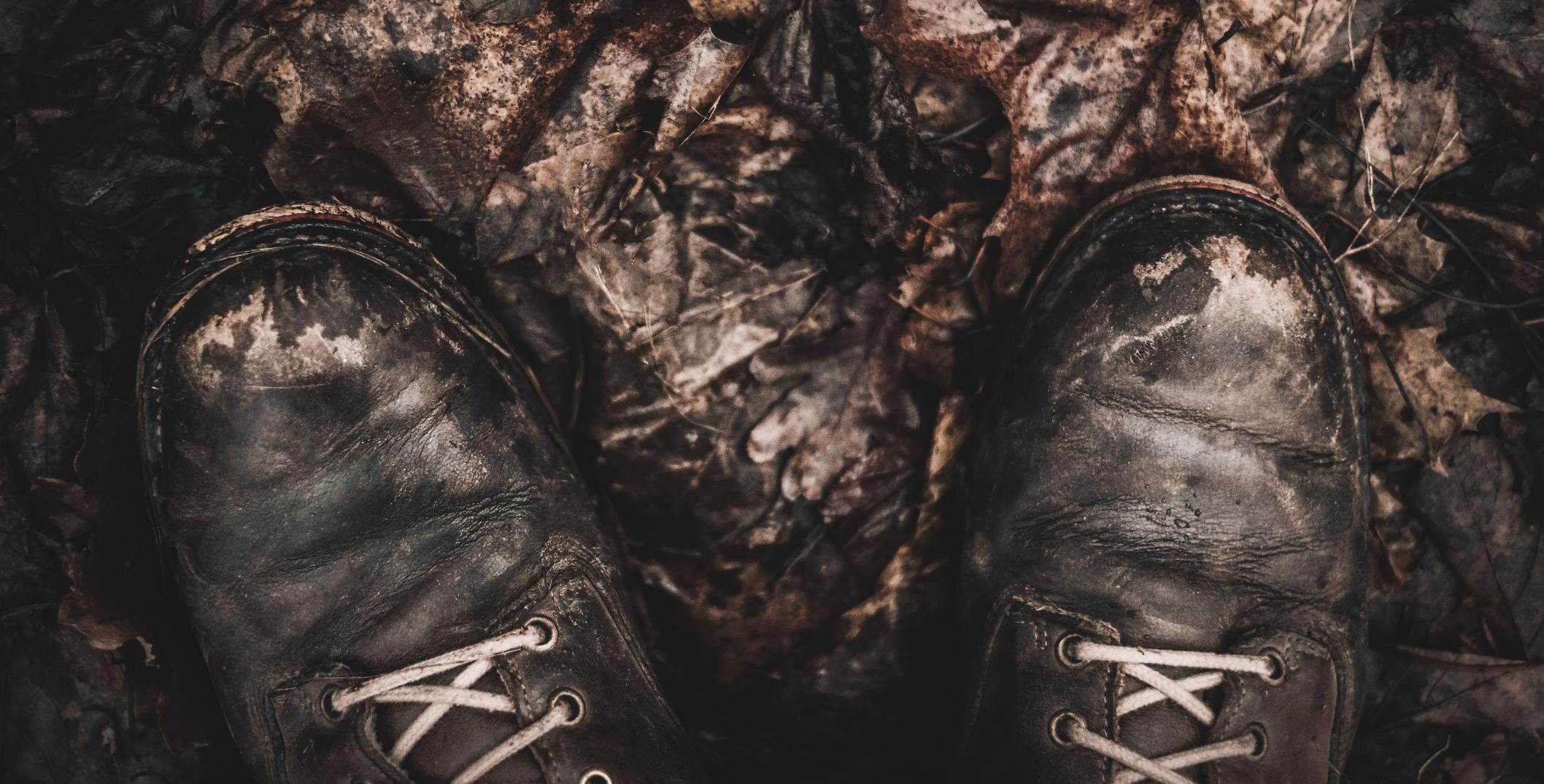 Boots on fallen autumn leaves