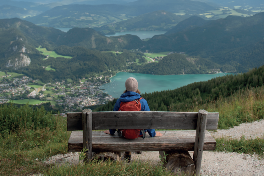 Person sitting in front of a valley
