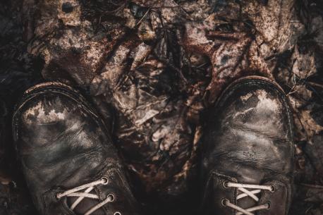 Boots on fallen autumn leaves